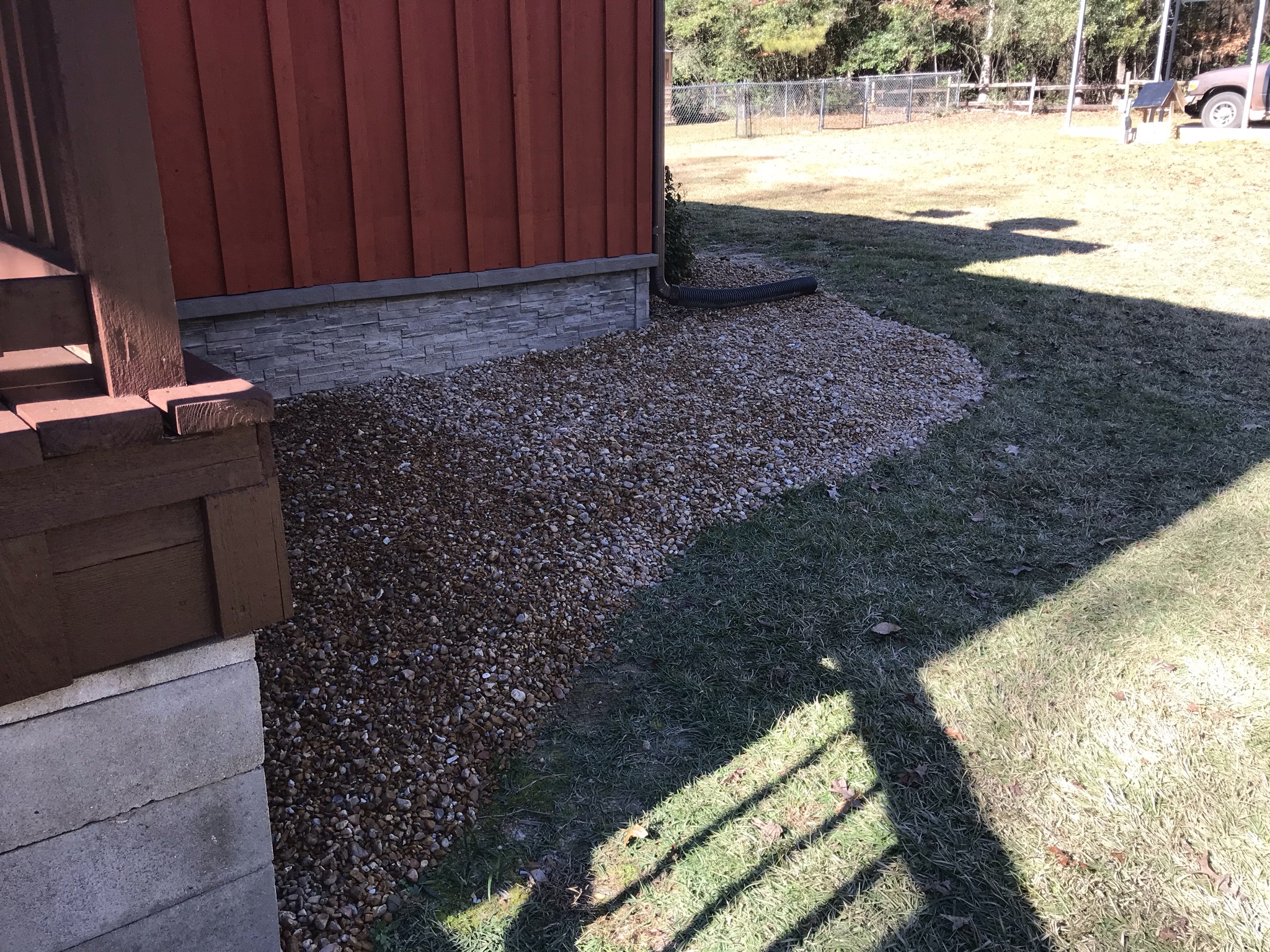 Rock bed along side of red building